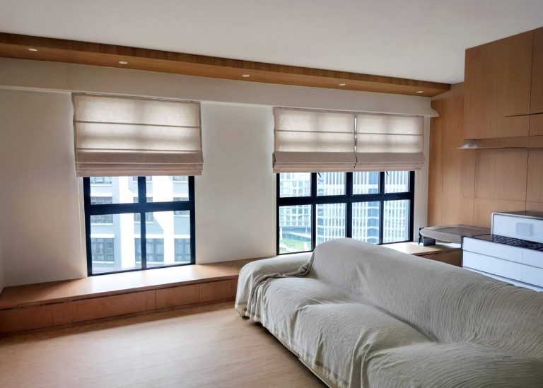 A modern Singapore bedroom featuring light-colored Roman blinds