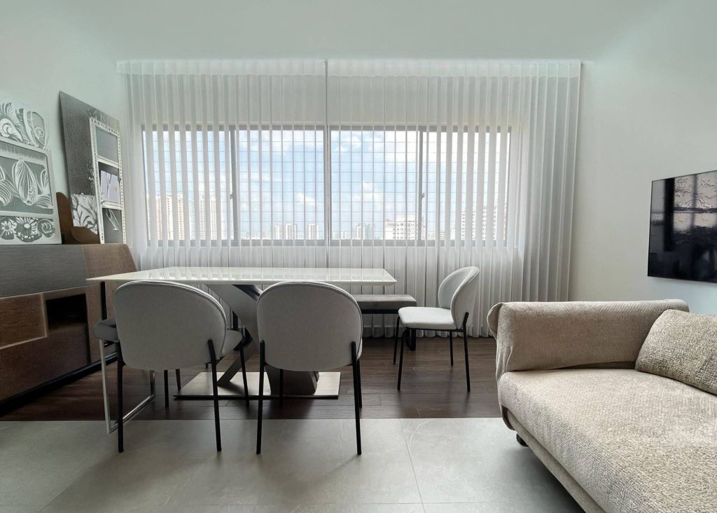 Close-up of elegant grey glass pendant light against blinds.