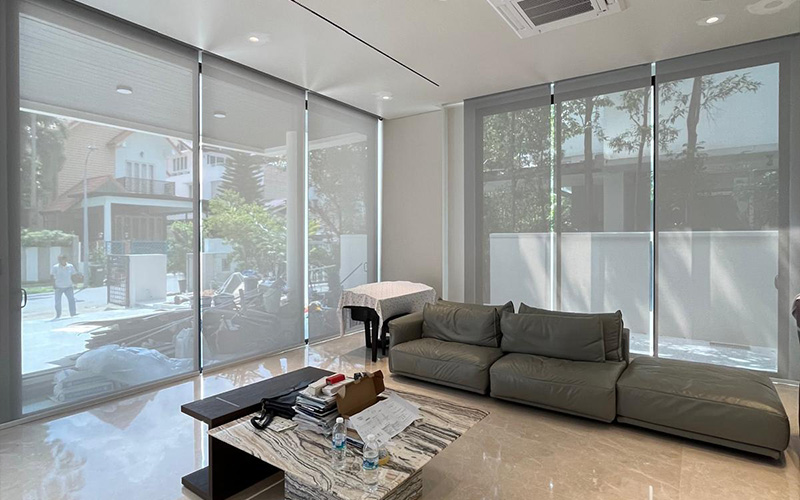 Large roller blinds measured and fitted for floor-to-ceiling living room windows.
