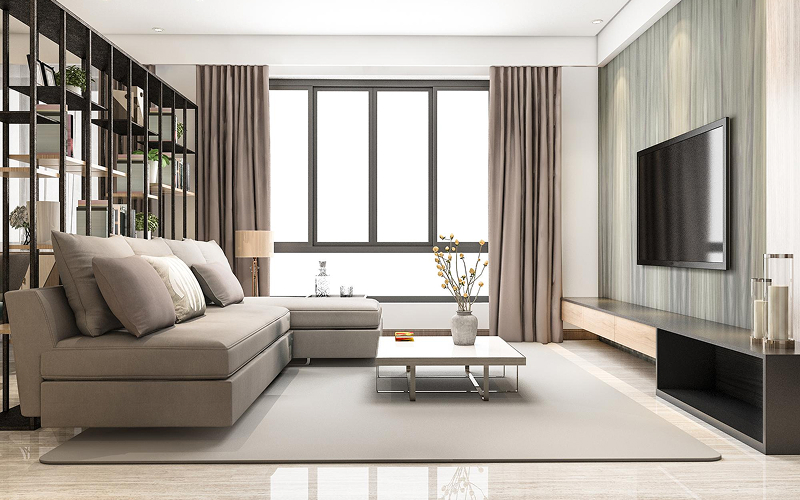 Modern living room featuring floor-to-ceiling neutral curtains.