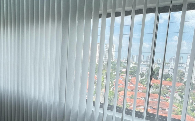 Light-filtering vertical blinds improving office comfort and natural light.