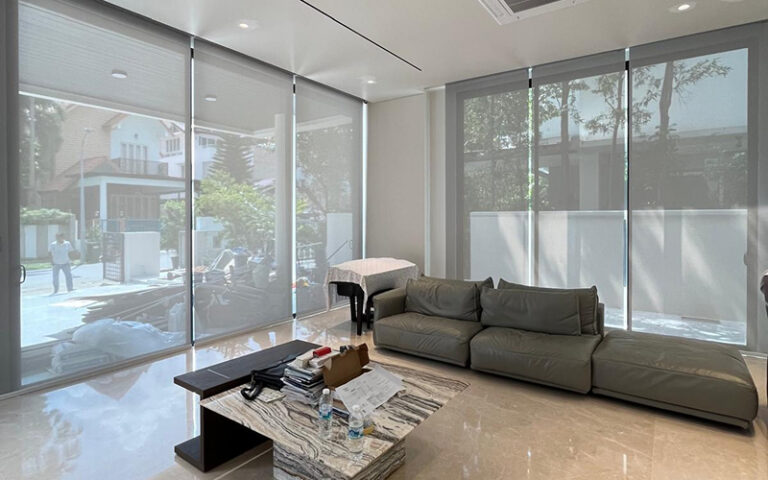 Modern roller blinds installed on large floor-to-ceiling windows.