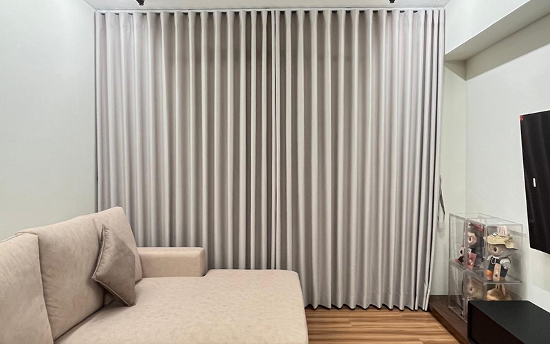 Full-length floor-to-ceiling ripple fold curtains for wide windows.