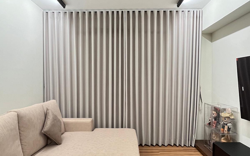 Light grey ripple fold curtains in a modern living room.