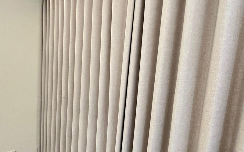 Close-up of beige vertical blinds.