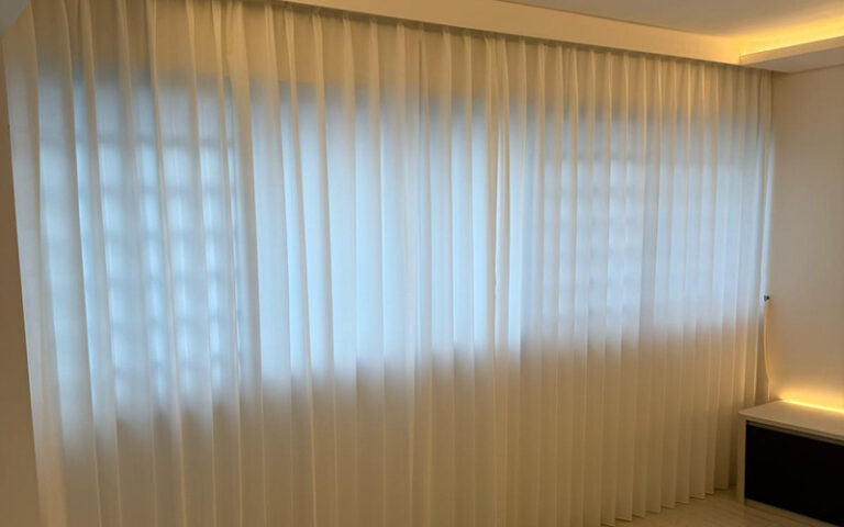 Sheer white floor-to-ceiling curtains for a soft, airy look.