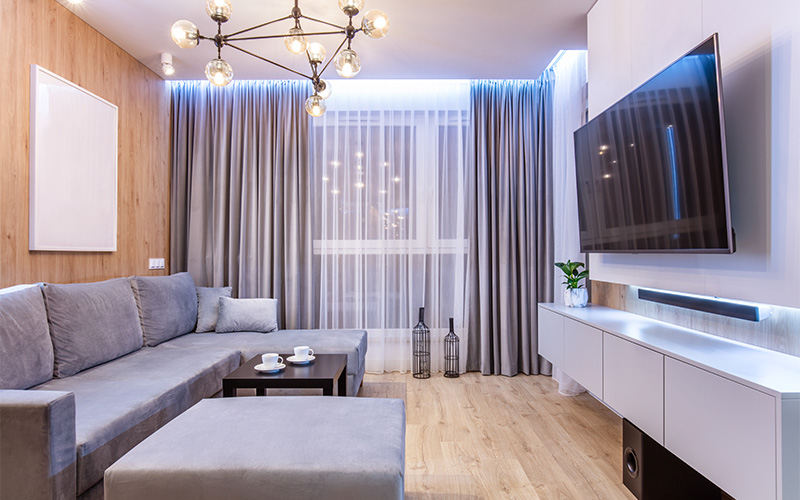 Minimalist living room with gray sectional sofa.
