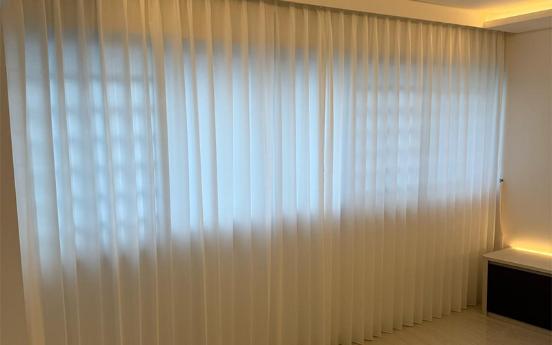 Modern interior with sheer white curtains.