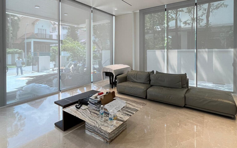 Modern living room with gray sofa and marble table.