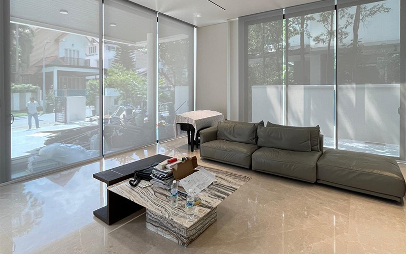 Modern living room with gray sofa and marble table.