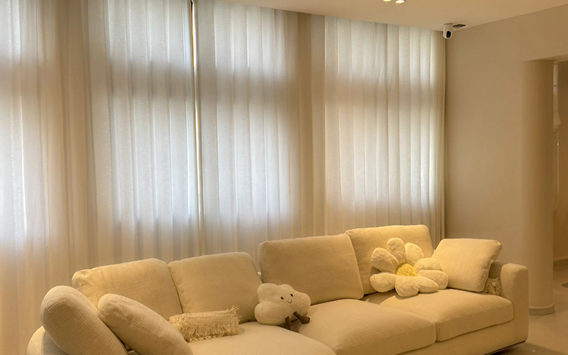 Sheer smart curtains in a modern white living room.